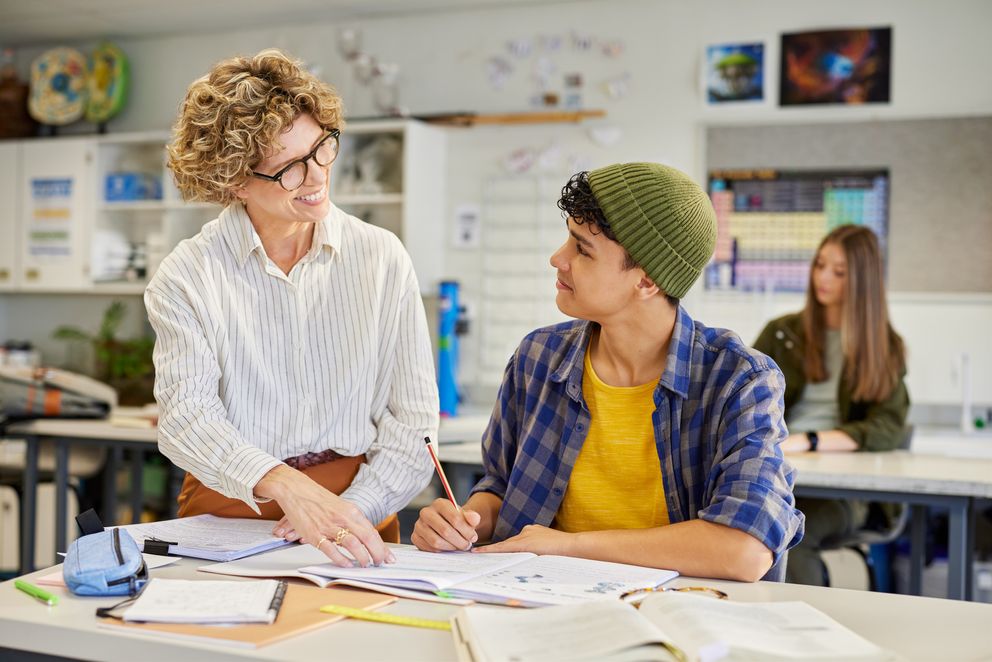 Lehrerin hilft Schüler im Unterricht
